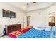 This bedroom features a ceiling fan, window, tray ceiling and carpet at 24608 E Moraine Pl, Aurora, CO 80016