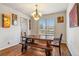 Dining area with natural light, a wooden table set, and decorative wall art creating a warm ambiance at 24608 E Moraine Pl, Aurora, CO 80016