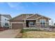 Charming single-Gathering home featuring stone accents, a covered porch, and an attached two-car garage at 24608 E Moraine Pl, Aurora, CO 80016