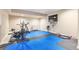 Home gym area featuring padded flooring, a flat screen TV, and various workout equipment at 24608 E Moraine Pl, Aurora, CO 80016