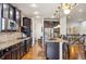 Open kitchen layout with island, stainless appliances, and rich wood cabinets at 24608 E Moraine Pl, Aurora, CO 80016