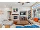 Spacious living room with a fireplace, large TV, and comfortable seating area at 24608 E Moraine Pl, Aurora, CO 80016