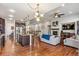 Spacious living room with hardwood floors, a fireplace, and an open layout to the kitchen at 24608 E Moraine Pl, Aurora, CO 80016