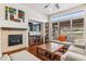 Inviting living room features a cozy fireplace, large window, and hardwood floors at 24608 E Moraine Pl, Aurora, CO 80016