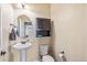 Cozy half bathroom with stylish pedestal sink and dark wood accents at 24608 E Moraine Pl, Aurora, CO 80016
