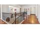 Stylish staircase showcasing hardwood floors and wrought iron railings, leading to the upper level at 24608 E Moraine Pl, Aurora, CO 80016