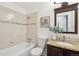Cozy bathroom featuring modern vanity, tub, and neutral wall colors at 7719 Everett Way, Arvada, CO 80005