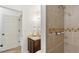 Updated bathroom showcasing a tiled shower, granite vanity, and modern fixtures for a fresh, clean aesthetic at 7719 Everett Way, Arvada, CO 80005