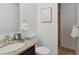 Updated bathroom features granite countertops, modern fixtures, and a glass-enclosed shower at 7719 Everett Way, Arvada, CO 80005