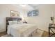 Bright bedroom features a large window, wood floors, and a comfortable bed at 7719 Everett Way, Arvada, CO 80005