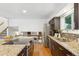 Well-appointed kitchen with stainless steel appliances, granite countertops, and a seamless transition to the upper floor at 7719 Everett Way, Arvada, CO 80005