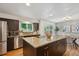 Kitchen with stainless steel appliances, granite countertops, and a center island, adjacent to the dining room at 7719 Everett Way, Arvada, CO 80005