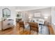Open-concept living room and dining room area featuring hardwood floors and neutral decor with an area rug at 7719 Everett Way, Arvada, CO 80005