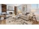 Cozy living room with a fireplace, soft lighting, and contemporary decor, perfect for relaxing and entertaining at 7719 Everett Way, Arvada, CO 80005