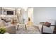 Inviting living room with an open staircase, modern furnishings, and ample natural light at 7719 Everett Way, Arvada, CO 80005