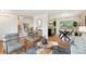 Open concept living room area with stairs, a kitchen, and a dining area visible in the background at 7719 Everett Way, Arvada, CO 80005