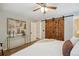 Relaxing main bedroom with barn door closet, comfortable bedding, and soft lighting for a cozy ambiance at 7719 Everett Way, Arvada, CO 80005
