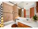 Bathroom featuring a tiled shower/tub, vanity, mirror, and decor at 14272 E Hawaii Cir # B, Aurora, CO 80012