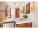 Bathroom featuring a vanity, sink, toilet, and tiled shower with glass doors at 14272 E Hawaii Cir # B, Aurora, CO 80012