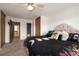 View of a primary bedroom with queen bed, access to the bathroom, and a closet at 14272 E Hawaii Cir # B, Aurora, CO 80012