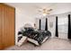 Bedroom with a queen bed, ceiling fan, closet, and windows with dark curtains at 14272 E Hawaii Cir # B, Aurora, CO 80012