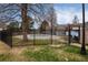 Community pool area enclosed by a black metal fence and surrounded by greenery at 14272 E Hawaii Cir # B, Aurora, CO 80012