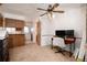 Bright room featuring a ceiling fan, a desk, and a view into the kitchen at 14272 E Hawaii Cir # B, Aurora, CO 80012