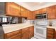 Kitchen featuring wood cabinets, countertop, and stainless steel appliances at 14272 E Hawaii Cir # B, Aurora, CO 80012