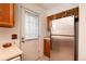 View of the kitchen with stainless steel refrigerator and door to the backyard at 14272 E Hawaii Cir # B, Aurora, CO 80012