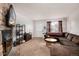 Inviting living room with a stone fireplace and brown sectional sofa at 14272 E Hawaii Cir # B, Aurora, CO 80012