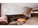 Cozy living room with a comfortable brown sectional sofa and staircase at 14272 E Hawaii Cir # B, Aurora, CO 80012