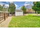 A well-maintained backyard featuring a shed and a mix of grass and gravel landscaping at 450 Yukon St, Lakewood, CO 80226