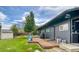 Exterior view of backyard featuring a wooden deck, spacious lawn, and shed with mature landscaping at 450 Yukon St, Lakewood, CO 80226