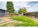 Spacious backyard featuring lush green grass and a wooden fence surrounding the perimeter at 450 Yukon St, Lakewood, CO 80226
