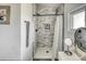 Bathroom featuring a shower with marble tile, black hardware, and a window, with a vanity nearby at 450 Yukon St, Lakewood, CO 80226