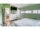 Bright green bedroom with white accents, modern dresser, and comfortable decor at 450 Yukon St, Lakewood, CO 80226