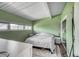 Green bedroom with a cozy rug, closet space, and natural light from multiple windows at 450 Yukon St, Lakewood, CO 80226