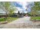 Landscaped front yard and long driveway leading to a modern home with large windows at 450 Yukon St, Lakewood, CO 80226
