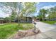 Contemporary gray home featuring a well-manicured lawn, modern windows, and an extended driveway at 450 Yukon St, Lakewood, CO 80226