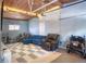 Garage converted to living space with projector, wood ceiling, basketball hoop, and comfortable seating at 450 Yukon St, Lakewood, CO 80226