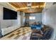 Garage converted to living space with projector, wood ceiling, basketball hoop, and comfortable seating at 450 Yukon St, Lakewood, CO 80226