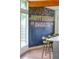 Kitchen island with bar seating, large windows, and a unique chalkboard wall at 450 Yukon St, Lakewood, CO 80226