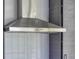 Stainless steel range hood over tile backsplash in an updated kitchen space at 450 Yukon St, Lakewood, CO 80226