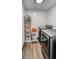 Laundry room with new stainless steel washer and dryer, shelving, and wood floor at 450 Yukon St, Lakewood, CO 80226