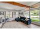Bright living room with vaulted ceilings, exposed wood beams, large windows, and a comfortable seating area at 450 Yukon St, Lakewood, CO 80226