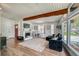Open-concept living room showcasing wood floors, fireplace, large windows, and a cozy seating arrangement at 450 Yukon St, Lakewood, CO 80226