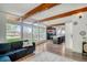 Sunlit living room with an open floor plan, large windows, hardwood floors, and easy access to the kitchen at 450 Yukon St, Lakewood, CO 80226