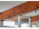 Close-up of wood beam ceiling feature with stylish light fixtures and expansive natural lighting at 450 Yukon St, Lakewood, CO 80226