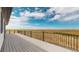 An expansive backyard view from the back deck of the home with metal railings and blue skies at 56315 E 74Th Ave, Strasburg, CO 80136