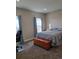Comfortable bedroom with bright windows, chair, and a wood chest at 56315 E 74Th Ave, Strasburg, CO 80136